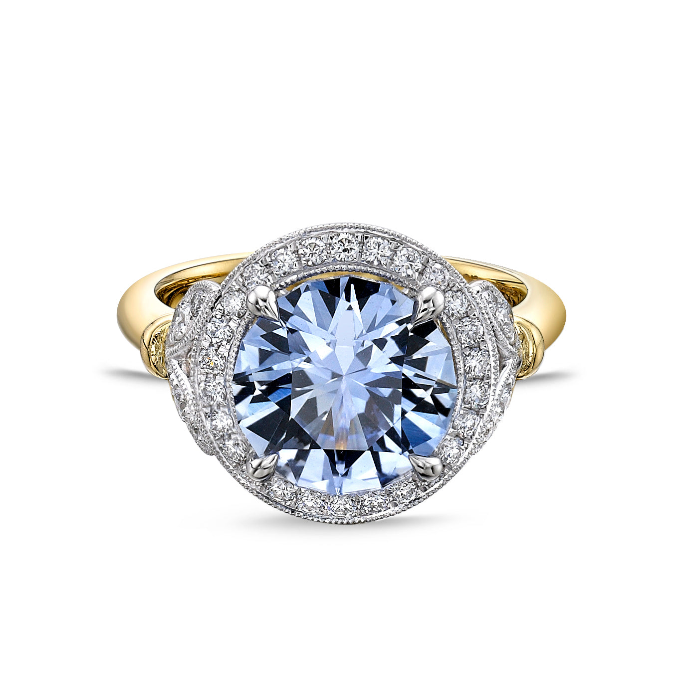 Cornflower blue sapphire engagement ring with a diamond halo and diamond-set detailing in platinum and yellow gold by Chantel Shafie Jewellery.