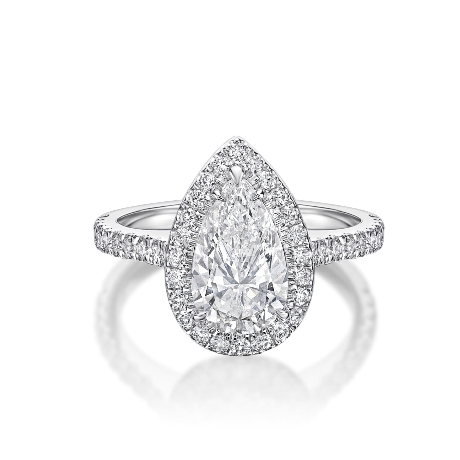 Pear shaped diamond engagement ring with a pavé diamond halo and diamond-set platinum band by Chantel Shafie Jewellery.